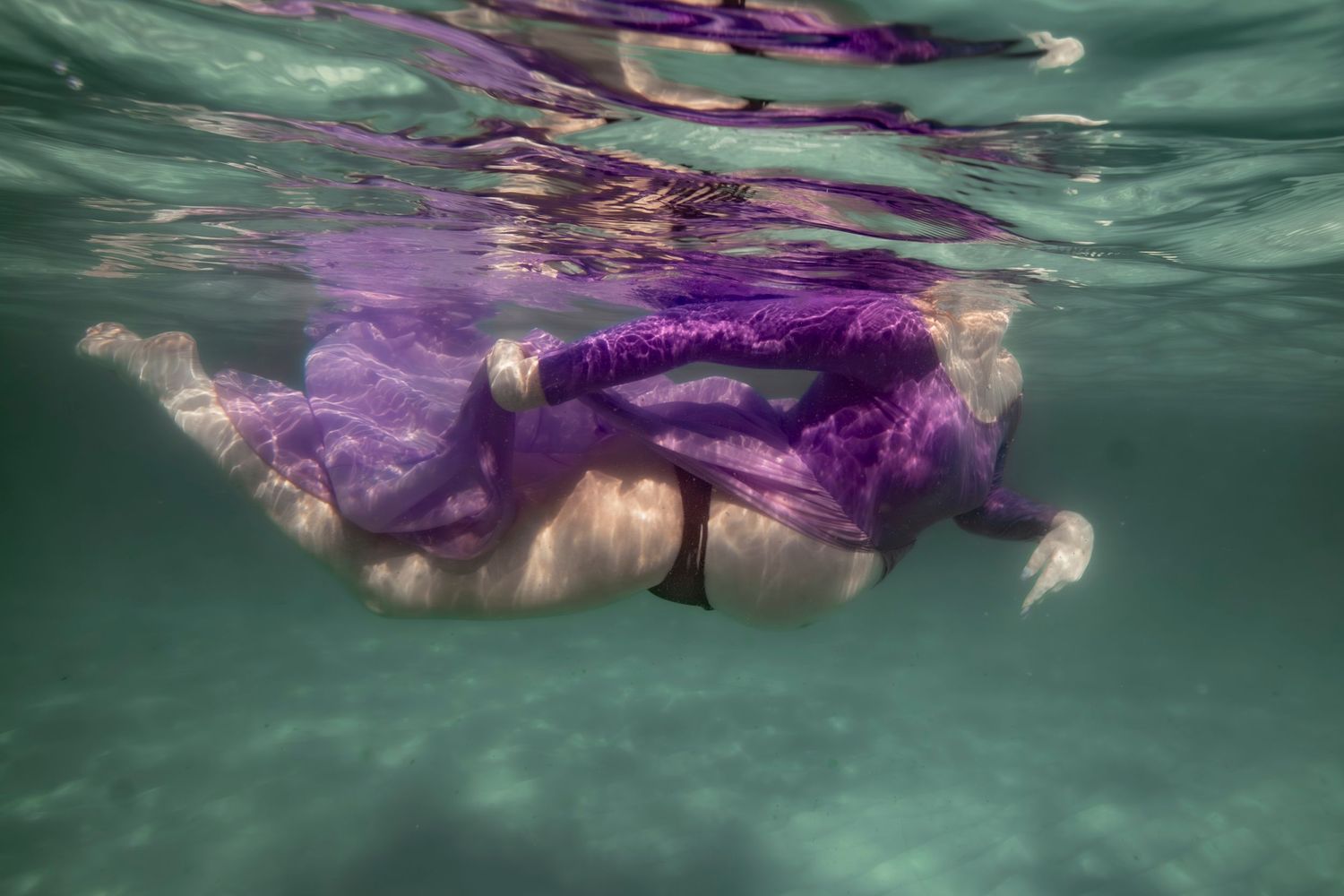 Cinematic underwater photo, in a documentary style, magical underwater photoshoot. Destination Elopement, maternity underwater photographer