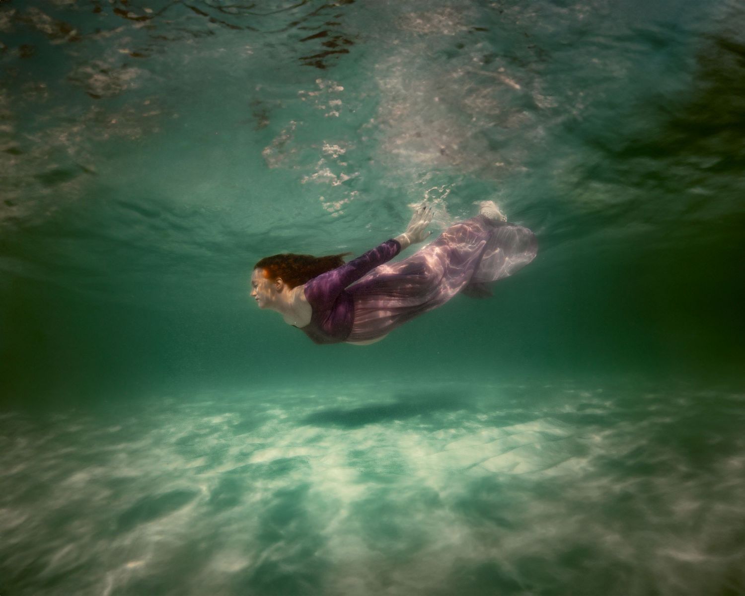 Cinematic underwater photo, in a documentary style, magical underwater photoshoot. Destination Elopement, maternity underwater photographer