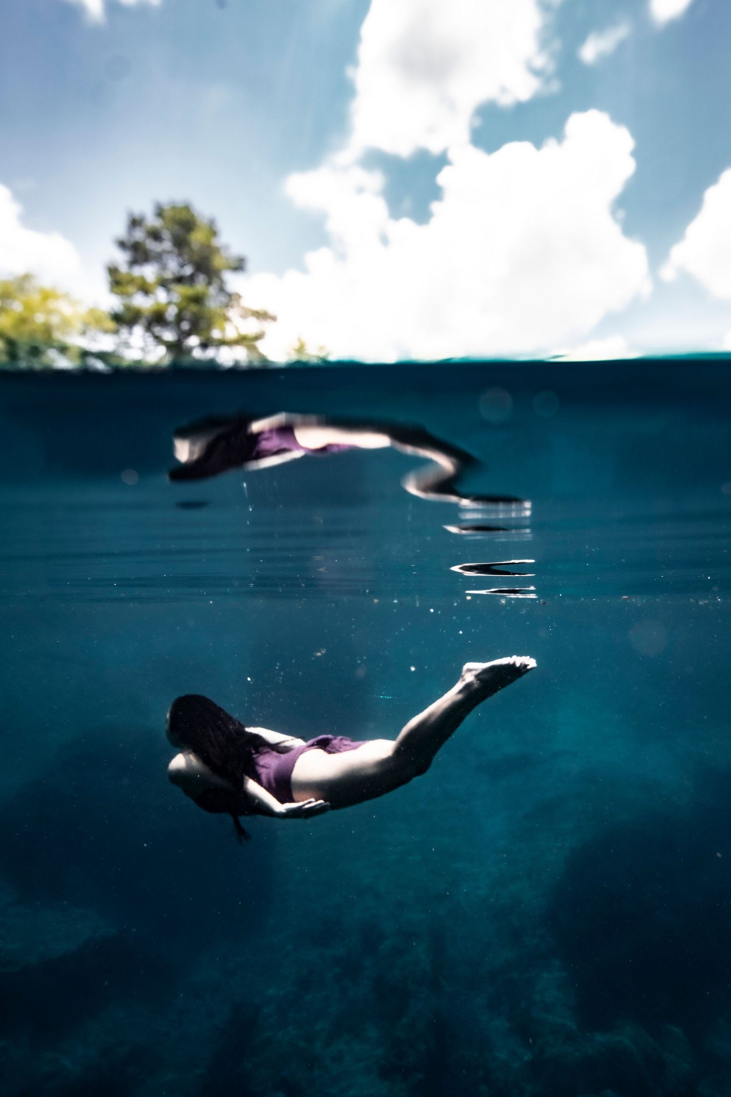 Cinematic underwater photo, in a documentary style, magical underwater photoshoot. Destination Elopement, maternity underwater photographer