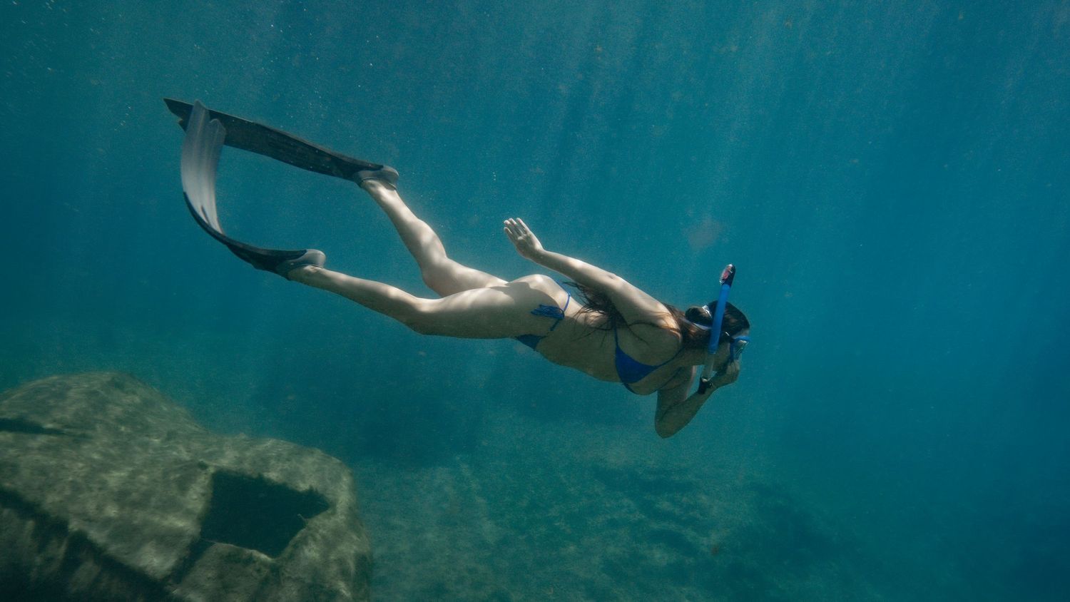 Cinematic underwater photo, in a documentary style, magical underwater photoshoot. Destination Elopement, maternity underwater photographer