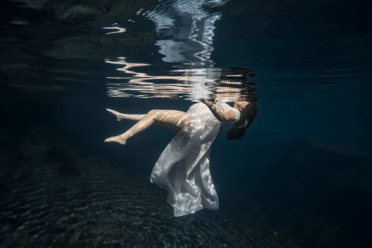 Cinematic underwater photo, in a documentary style, magical underwater photoshoot. Destination Elopement, maternity underwater photographer