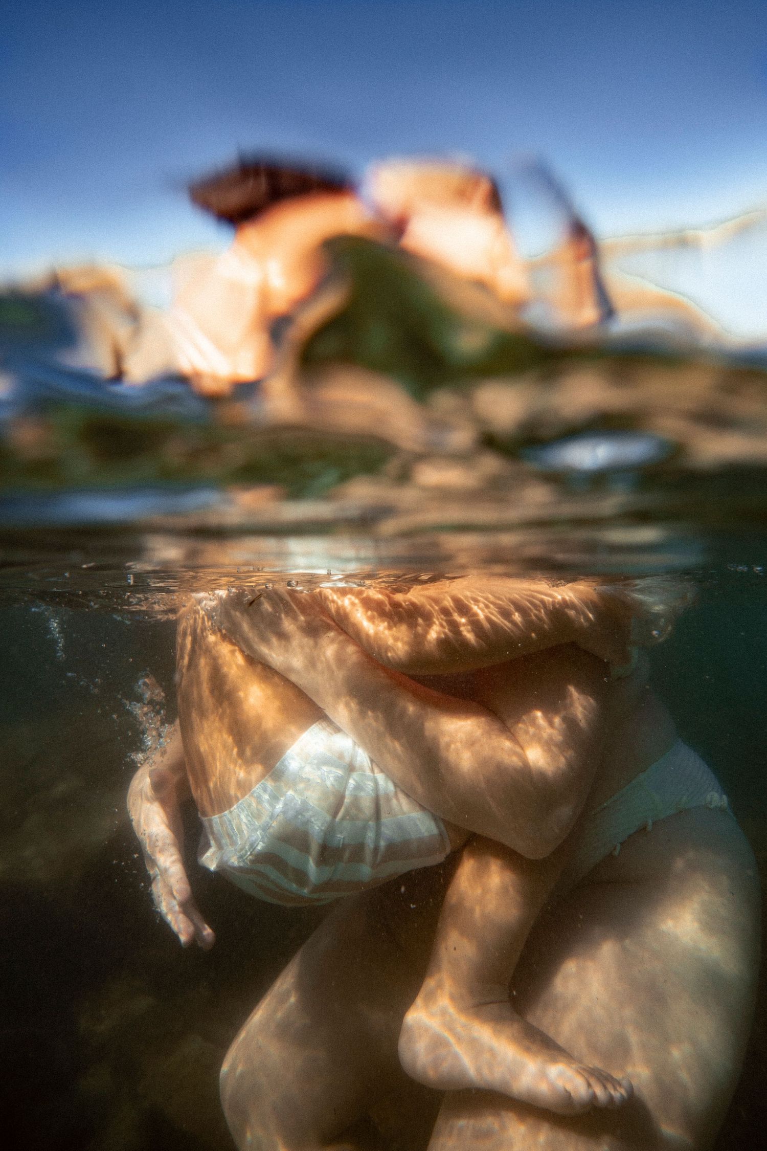 Cinematic underwater photo, in a documentary style, magical underwater photoshoot. Destination Elopement, maternity underwater photographer