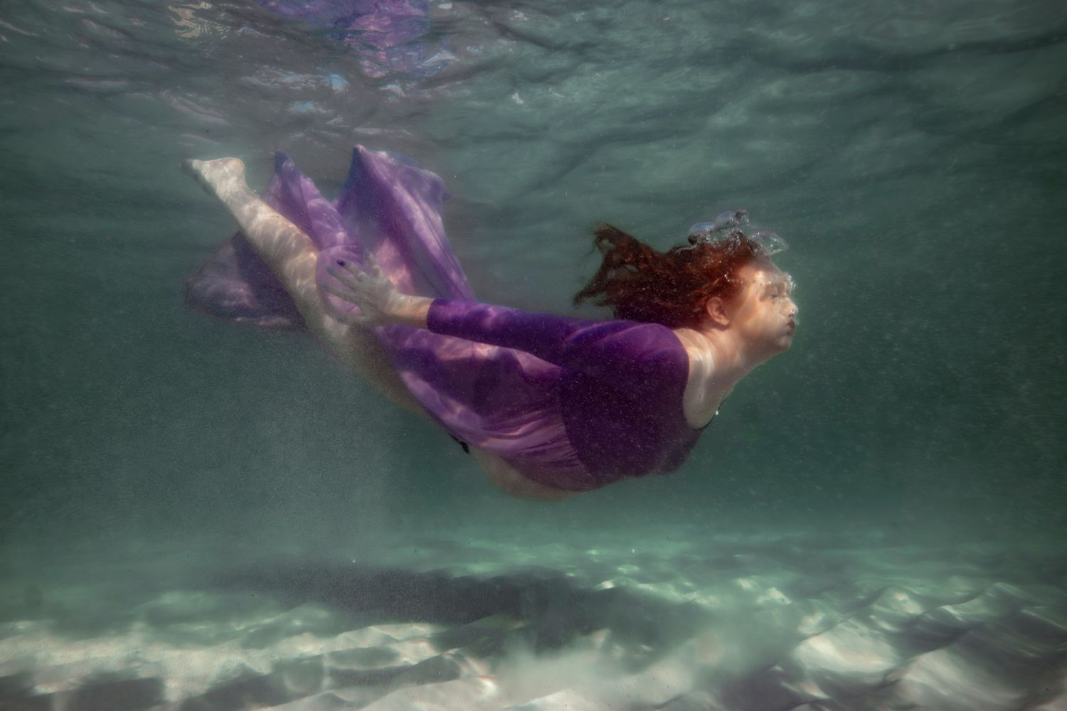 Cinematic underwater photo, in a documentary style, magical underwater photoshoot. Destination Elopement, maternity underwater photographer