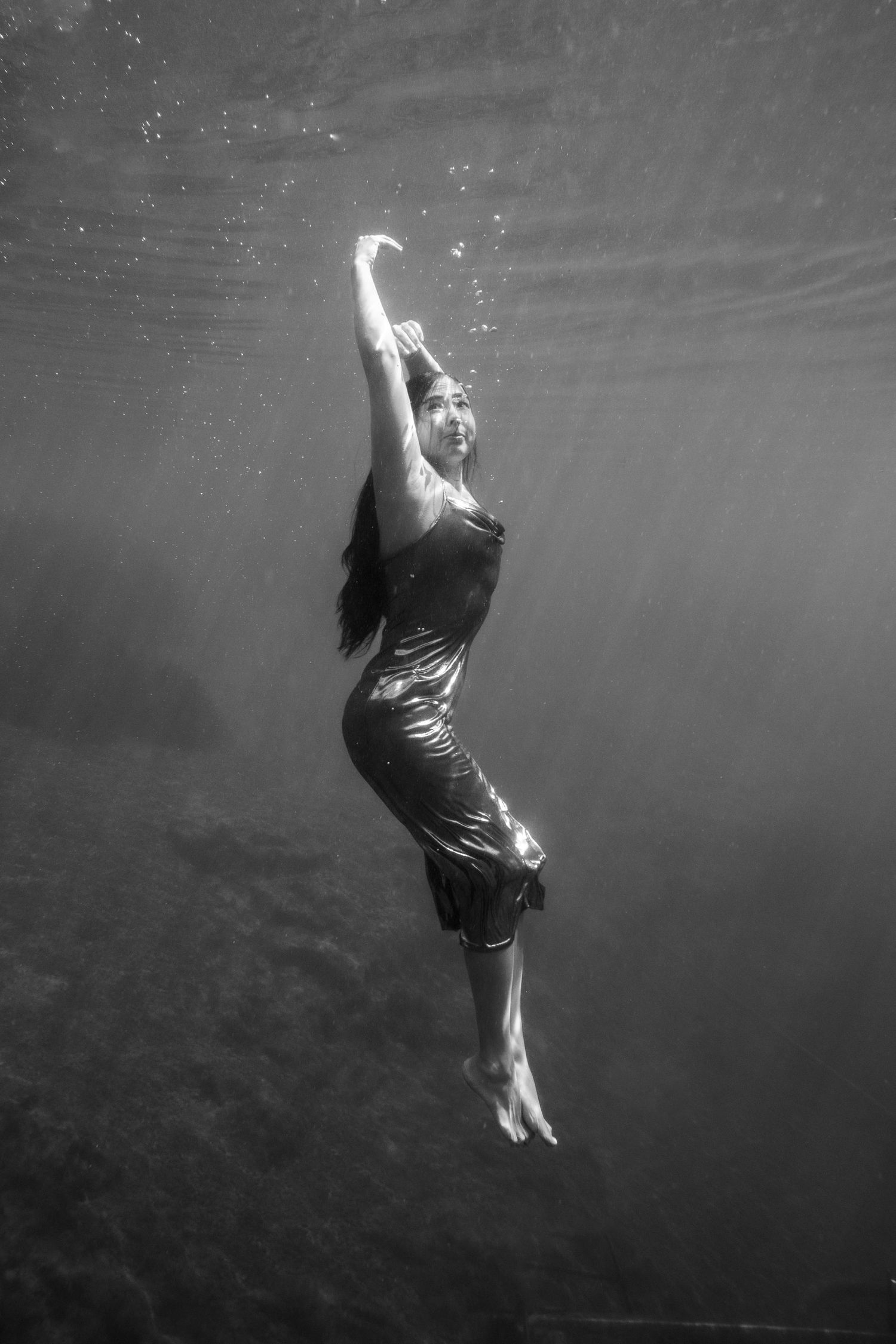 Cinematic underwater photo, in a documentary style, magical underwater photoshoot. Destination Elopement, maternity underwater photographer