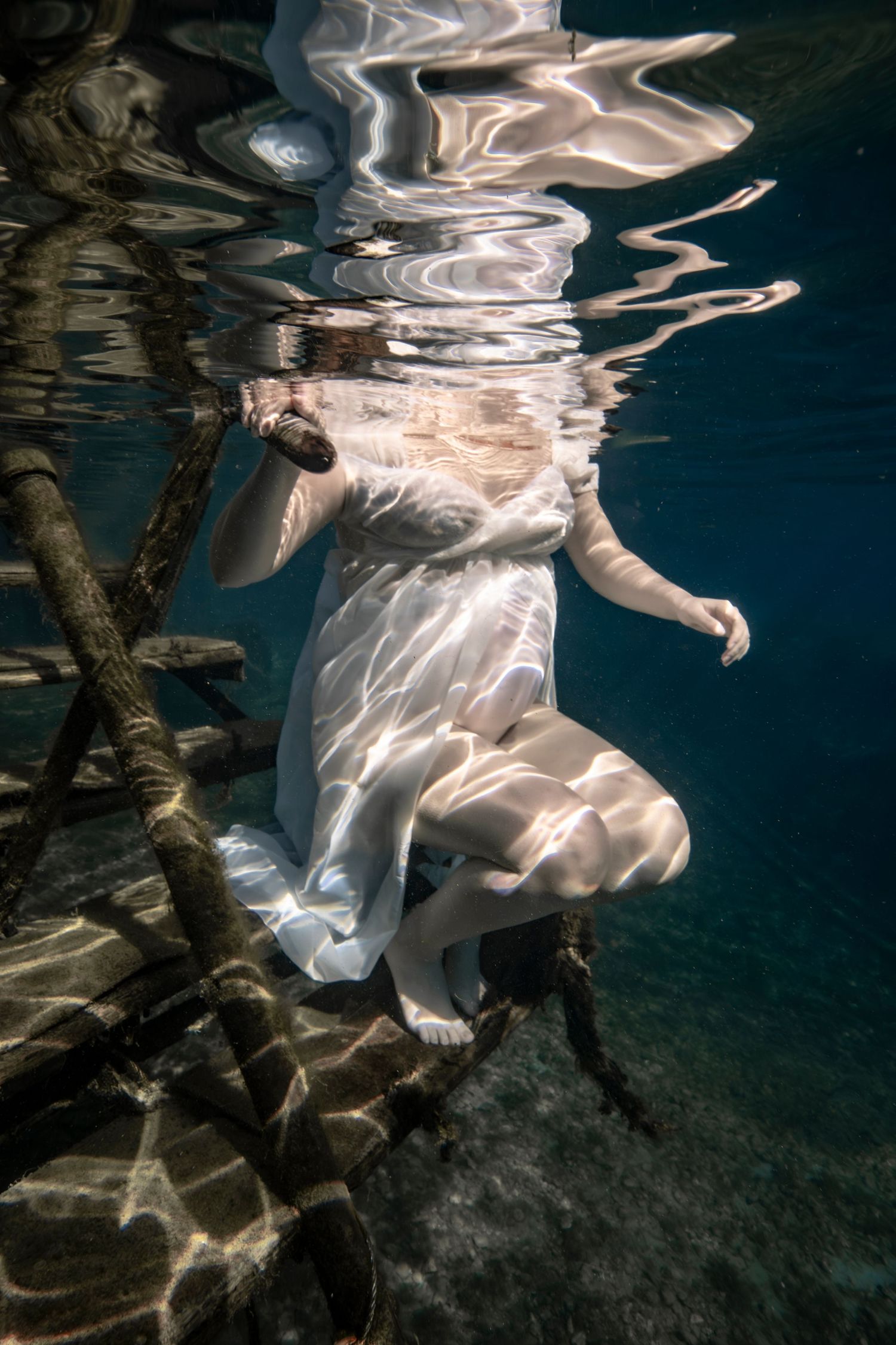 Cinematic underwater photo, in a documentary style, magical underwater photoshoot. Destination Elopement, maternity underwater photographer