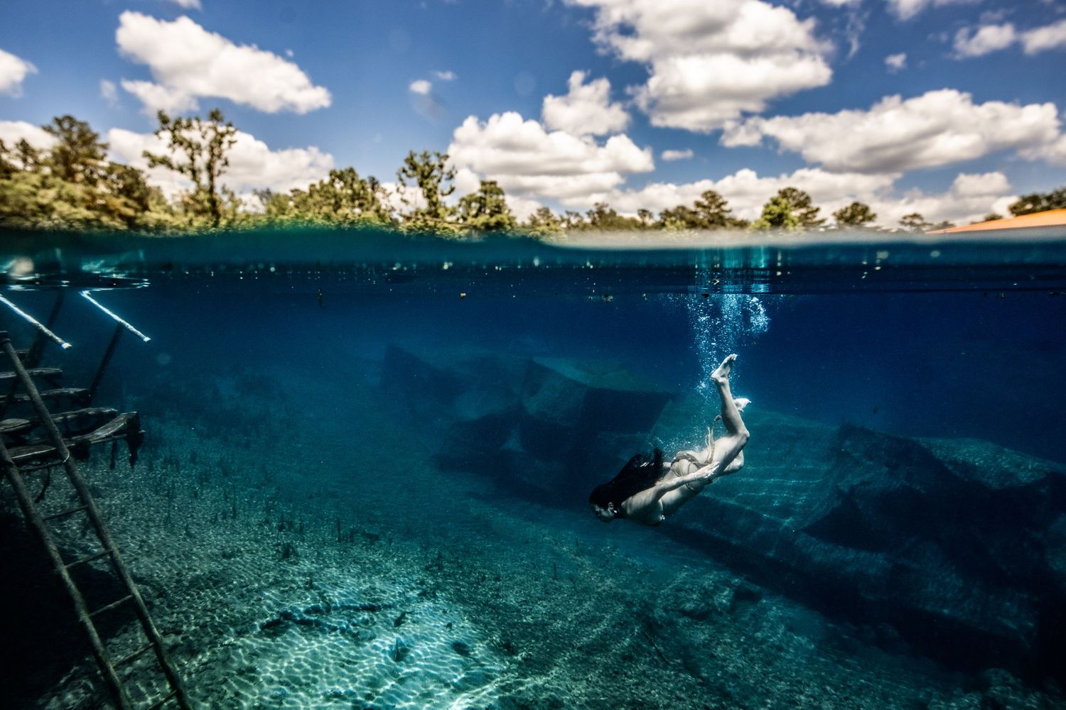 Cinematic underwater photo, in a documentary style, magical underwater photoshoot. Destination Elopement, maternity underwater photographer