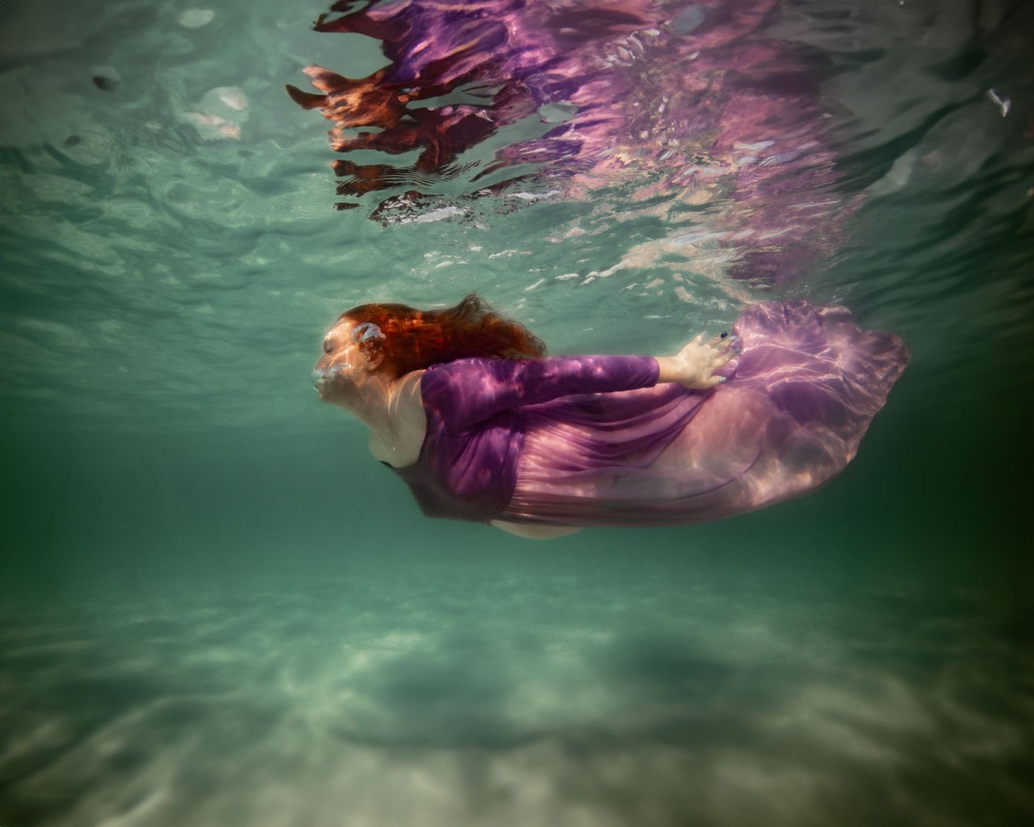 Cinematic underwater photo, in a documentary style, magical underwater photoshoot. Destination Elopement, maternity underwater photographer