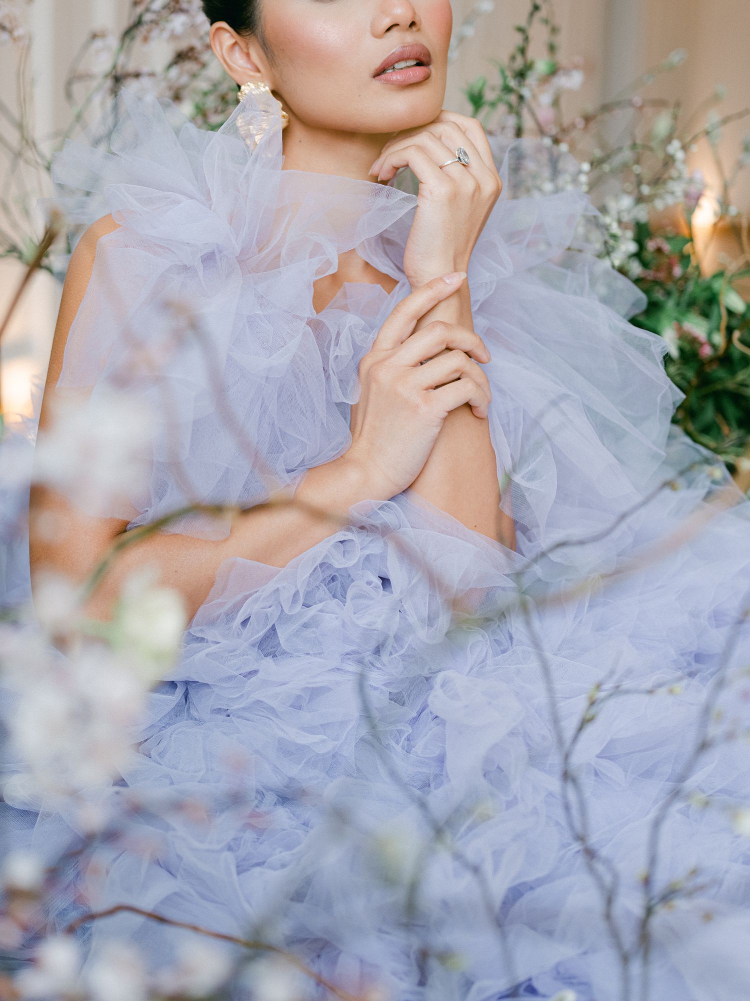 Ethereal portrait featuring delicate lavender tulle fabric and floral elements.