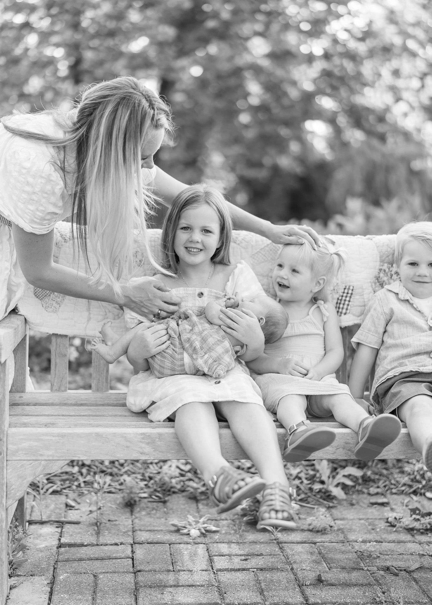 A black and white collage shows children sitting on a brick wall in an outdoor setting.