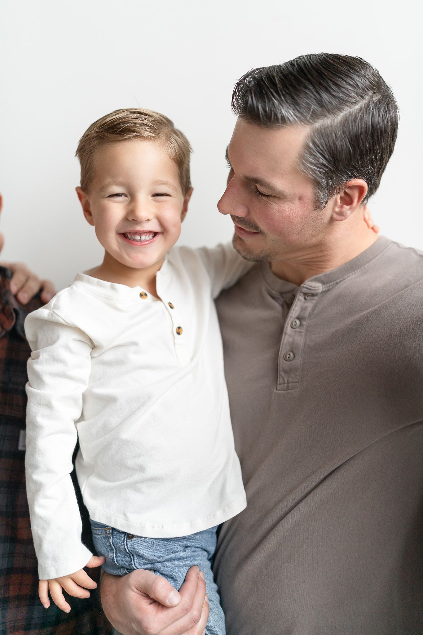 A heartwarming sequence of candid moments between a parent and child wearing a white shirt and jeans.