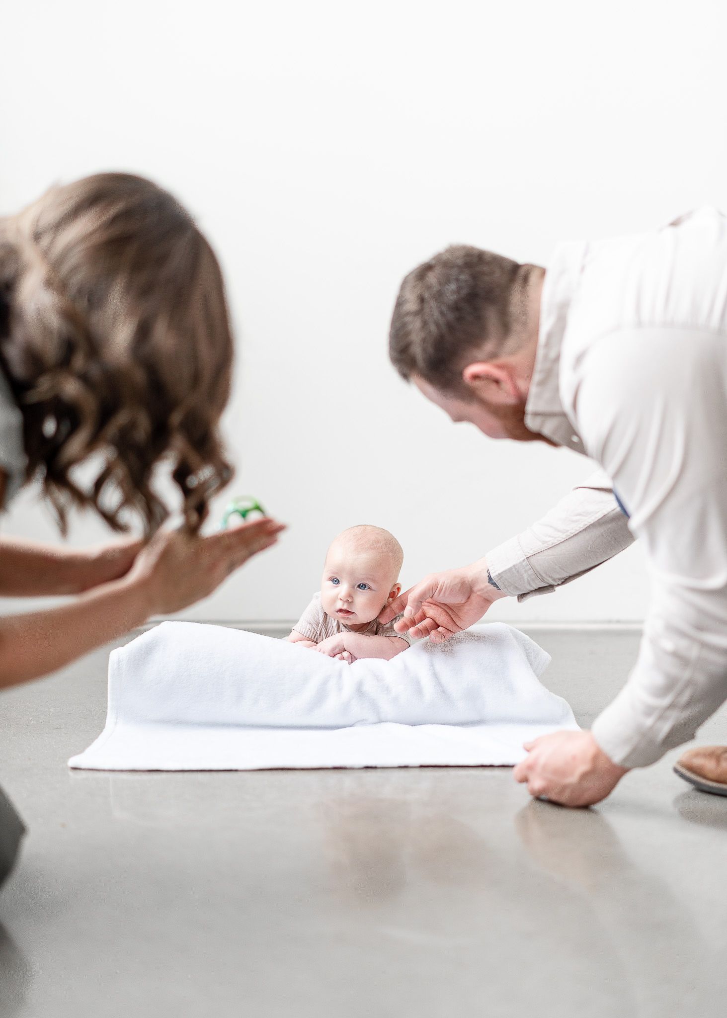 A series of five similar photos showing a baby being measured on a white surface during a medical examination.