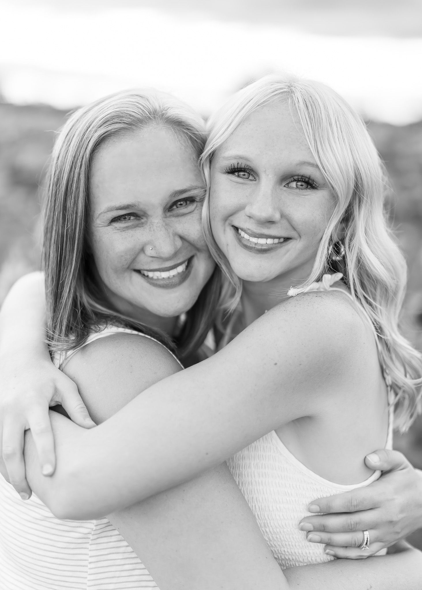 Black and white photo series showing intimate moments of affection between two people in white clothing.
