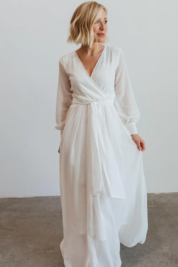 Flowy white wrap dress with long sleeves and empire waist shown in multiple angles against light background.