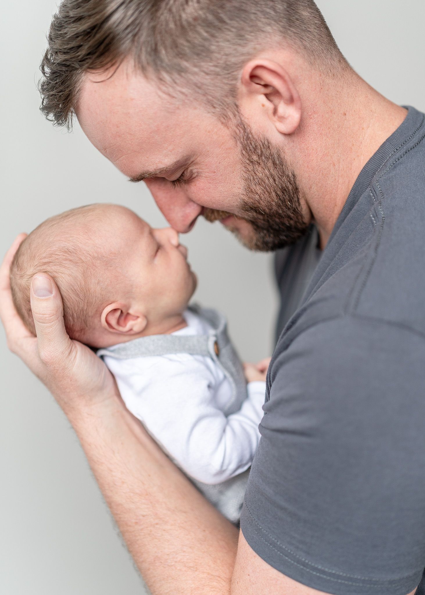 A tender moment between parent and baby as they touch noses in a series of heartwarming photos.