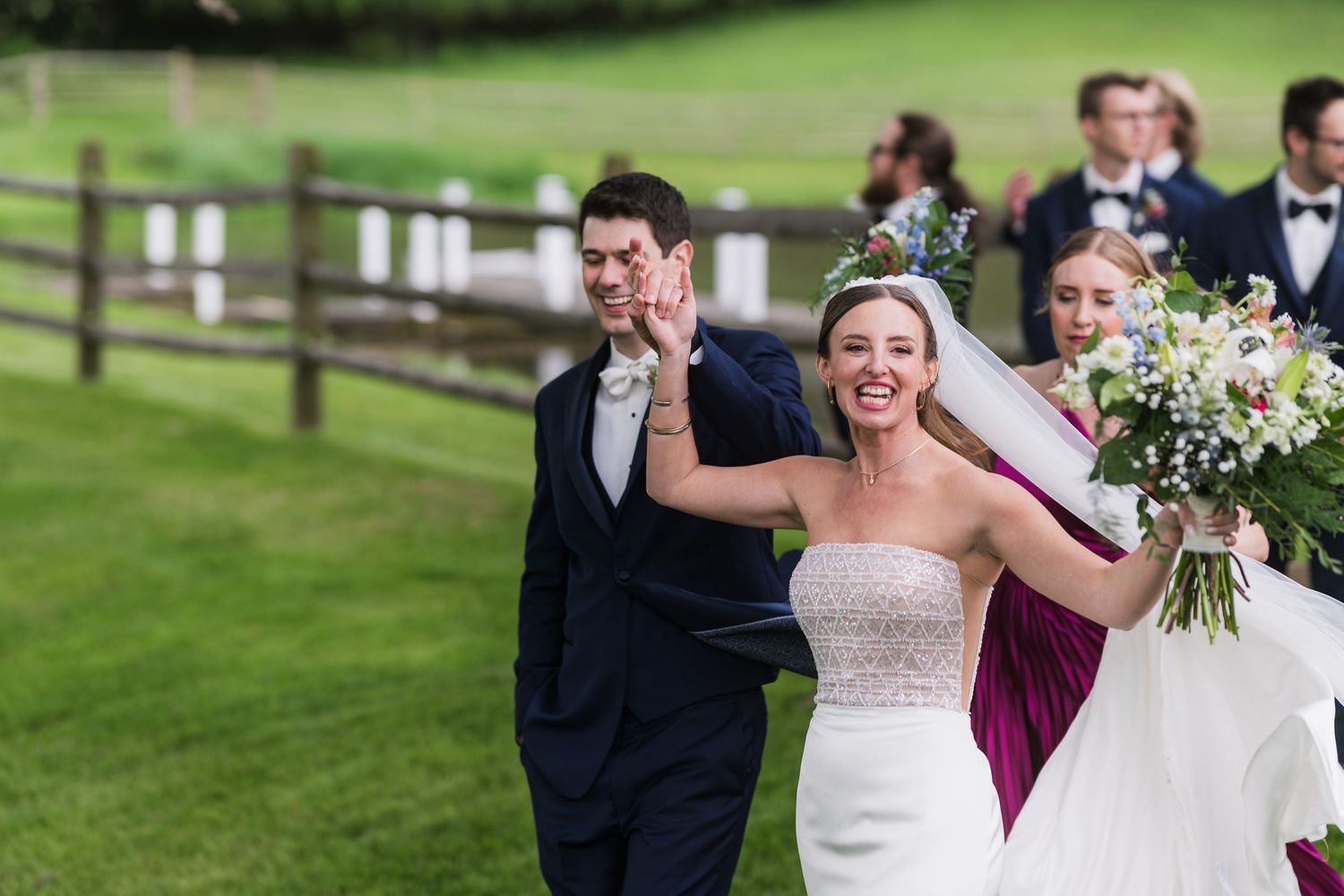 A joyful wedding celebration on lush green grounds with white fencing.  at shady elms farm pittsburgh pa photography and video