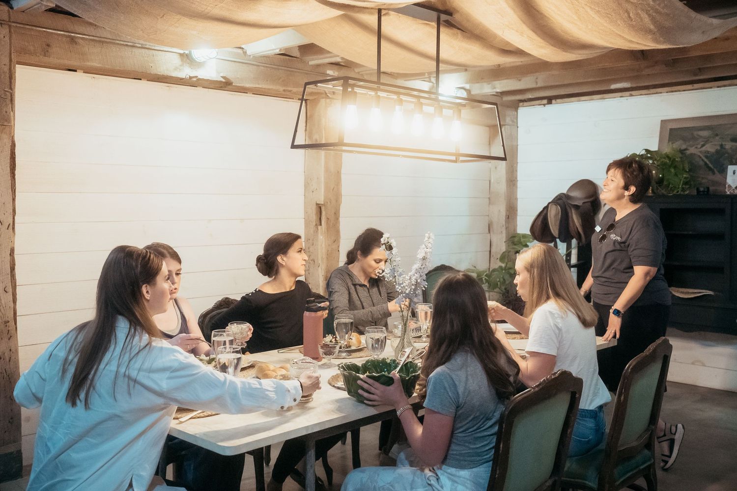 wedding party gathers around a rustic table at shady elm farms pittsburgh pa photography and video