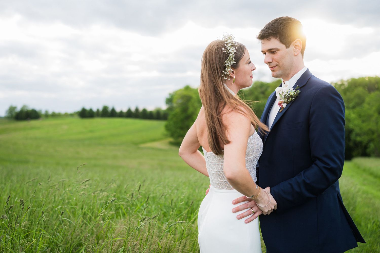 Romantic wedding couple portrait in a sunlit meadow surrounded by rolling hills.  at shady elms farm pittsburgh pa photography and video