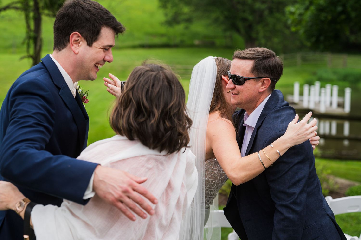 Joyful wedding couple embracing during outdoor celebration with guests.  at shady elms farm pittsburgh pa photography and video