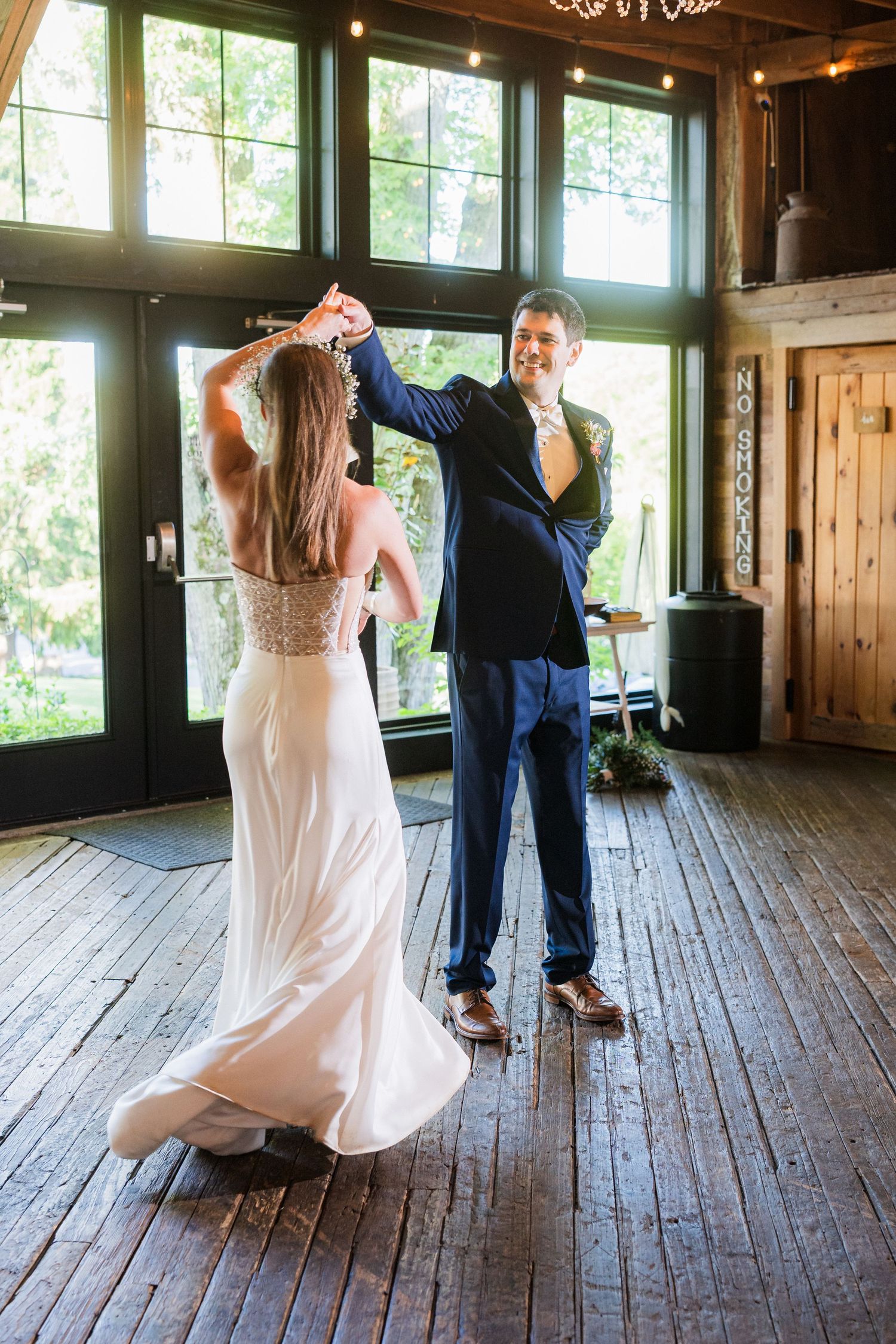 Couple sharing their first dance on rustic wooden floor with large windows.  at shady elms farm pittsburgh pa photography and video