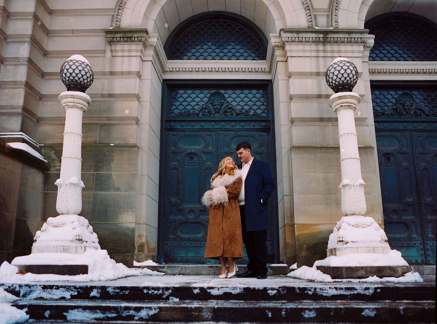 Film photography engagement session at Carnegie Museum of Art Pittsburgh, couple in editorial light, marble columns and moody warm tones.
