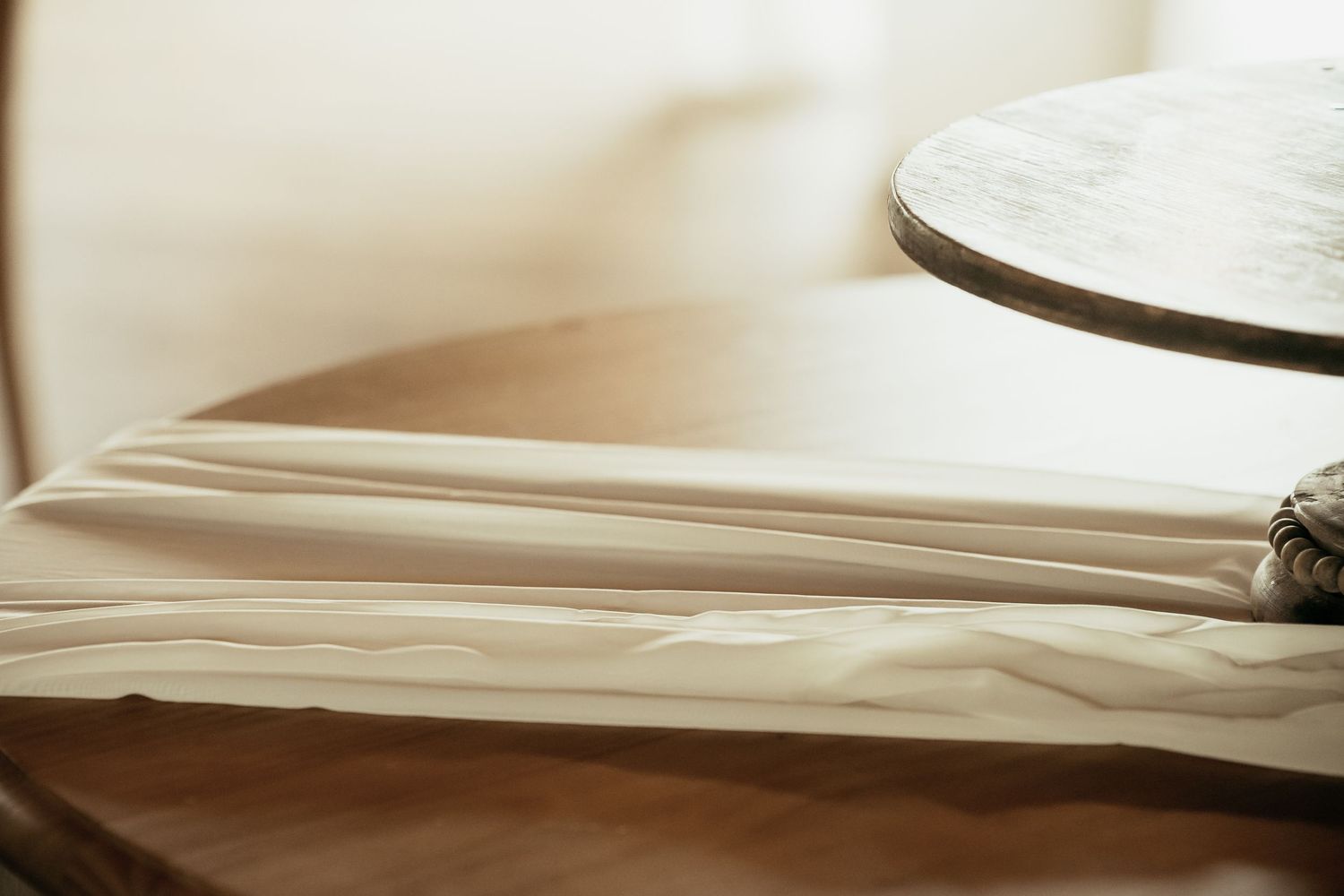 Soft focus detail of white linens in natural window light.