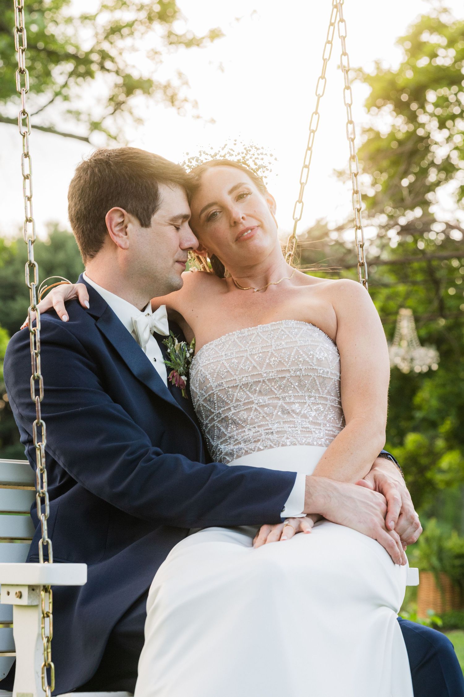 Newlyweds sharing intimate moment while sitting together on rustic swing outdoors at sunset  at shady elms farm pittsburgh pa photography a