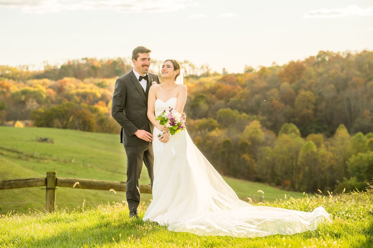 Couple embracing at golden hour among wildflowers and open fields during engagement session at Renshaw Farms, Freeport, PA.