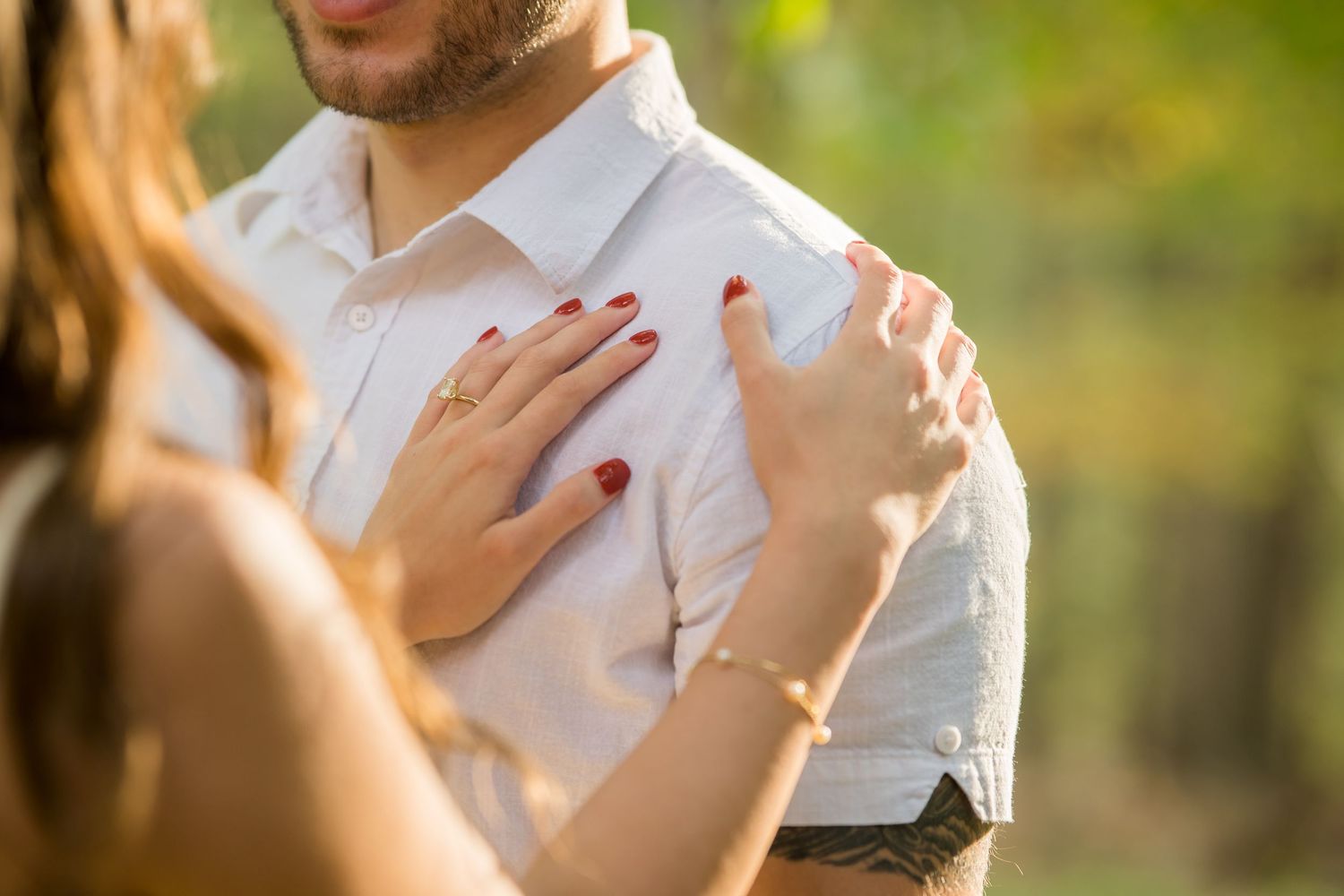 Couple during outdoor engagement photography session at Hartwood Acres Park, Pittsburgh, PA, surrounded by rolling hills and lush greenery.
