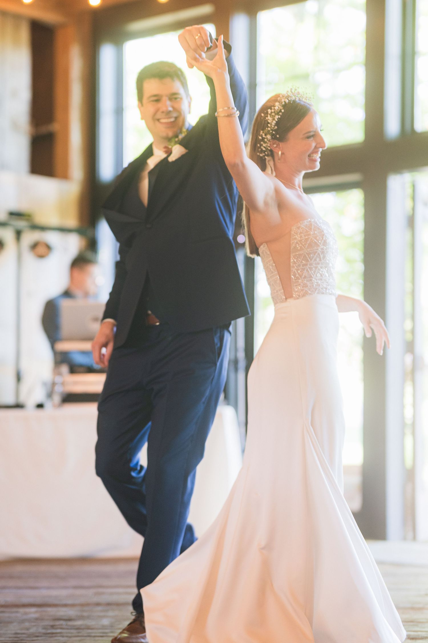 A celebratory dance moment at a wedding reception with raised arms and joyful expressions.