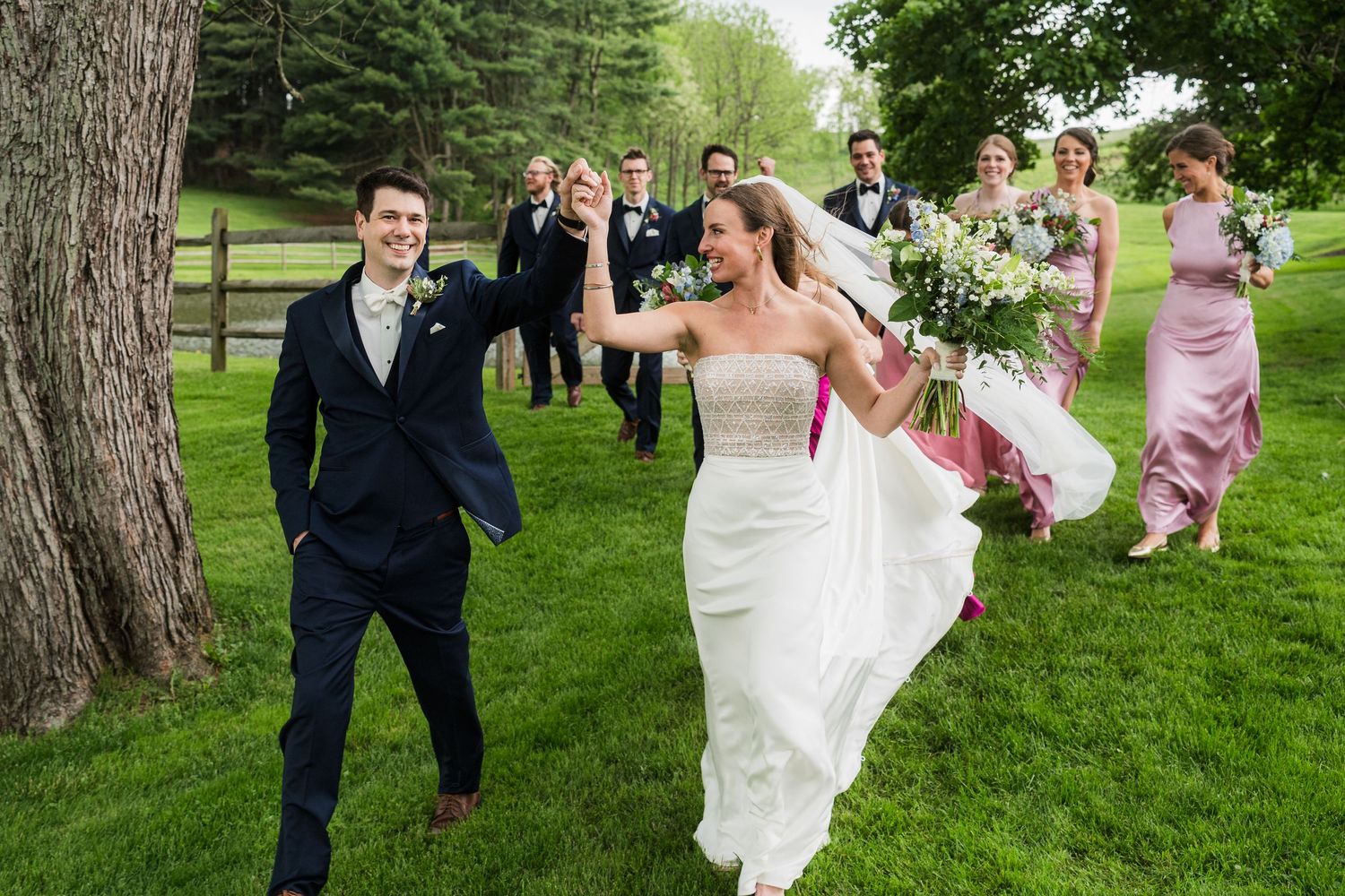 Wedding party celebrating on a beautiful green lawn with trees in the background.  at shady elms farm pittsburgh pa photography and video
