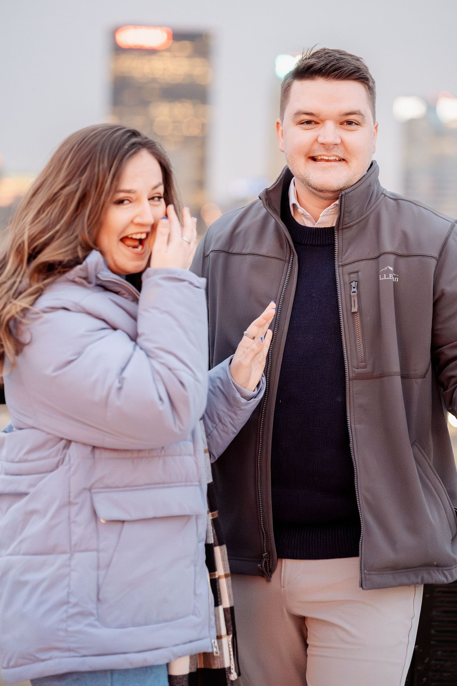 Couple embracing at sunset with Pittsburgh skyline and Ohio River views during engagement session at Duquesne Incline overlook, PA.