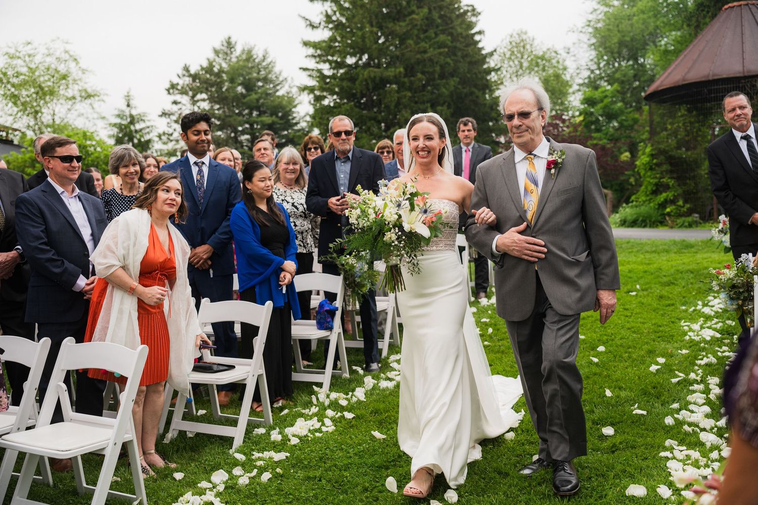 Wedding ceremony setup with white chairs and flower petals lining the aisle.  at shady elms farm pittsburgh pa photography and video