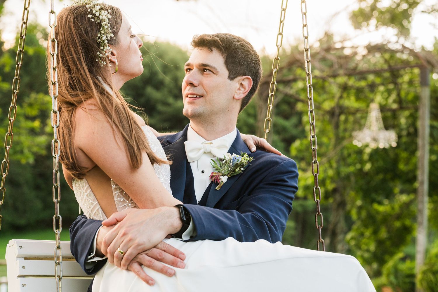 Romantic moment captured of newlyweds sharing an intimate moment on a garden swing.  at shady elms farm pittsburgh pa photography and video