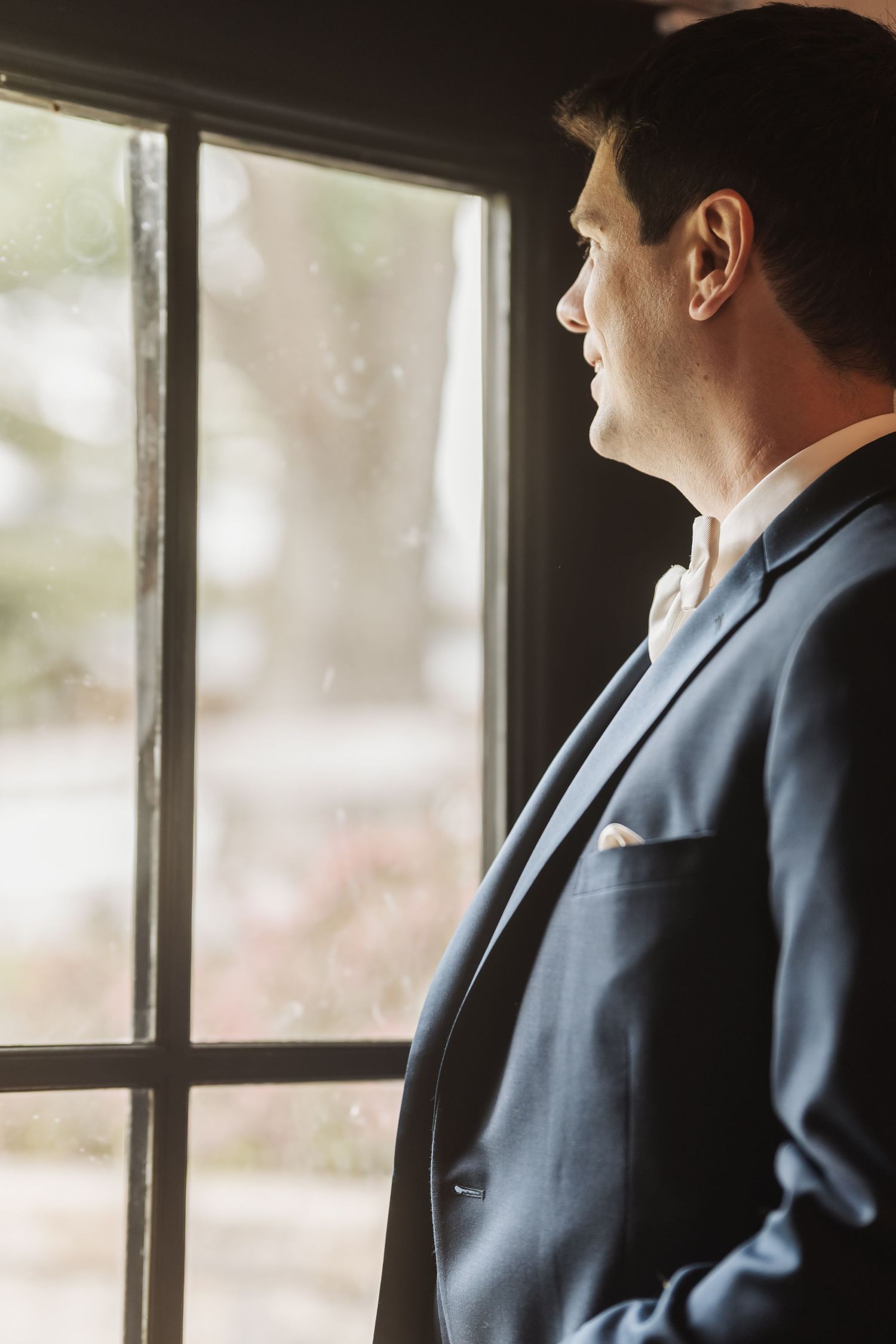 groom at window  at shady elms farm pittsburgh pa photography and video