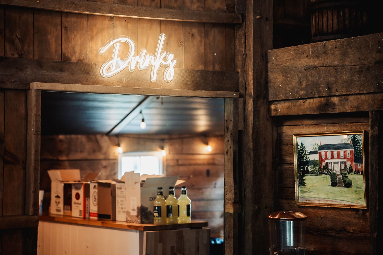 Interior of rustic barn venue with glowing drinks sign and wooden details. at shady elm farms pittsburgh pa photography and video wedding