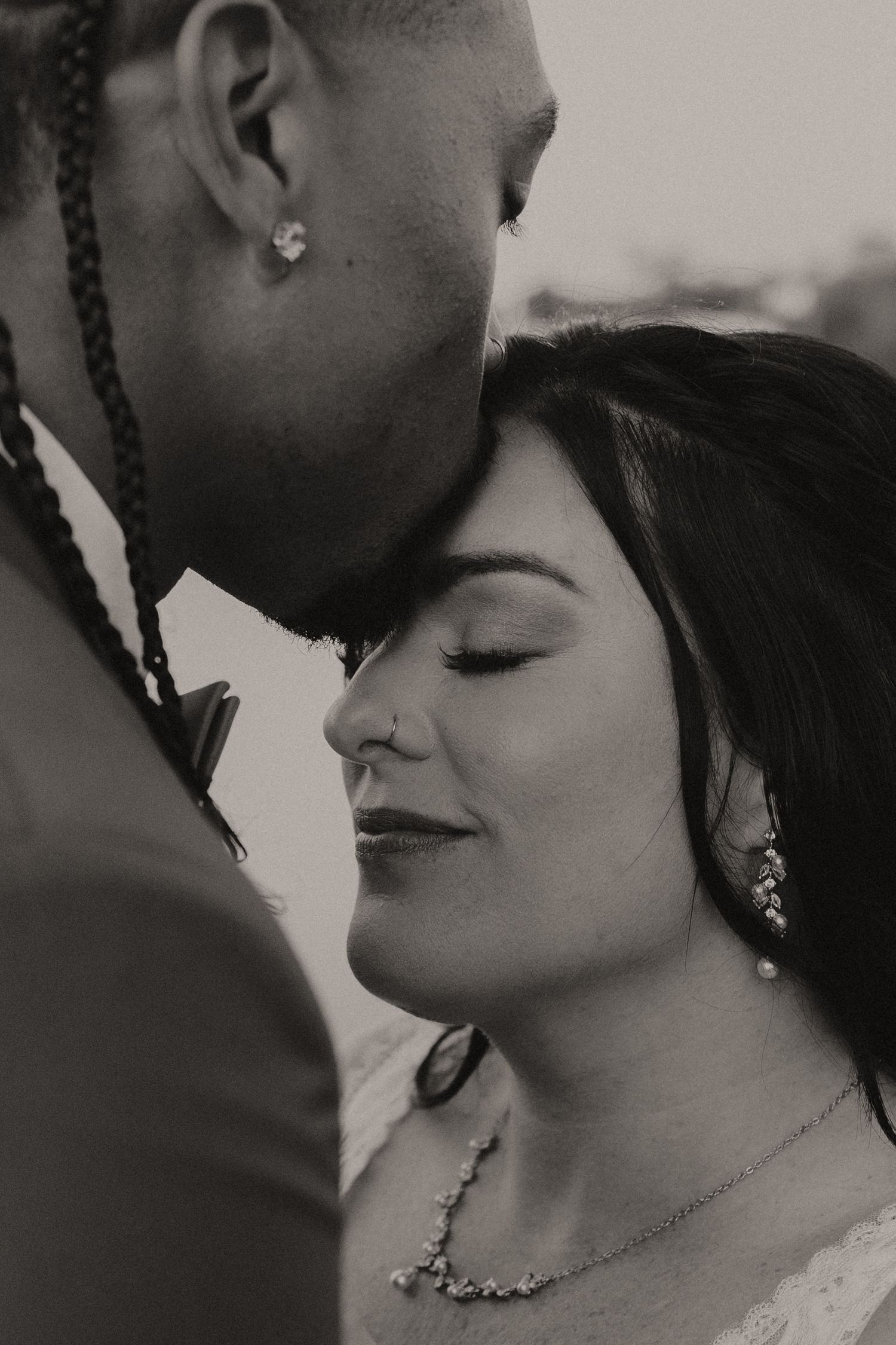 A romantic black and white photo sequence showing a couple in an intimate close-up moment together.