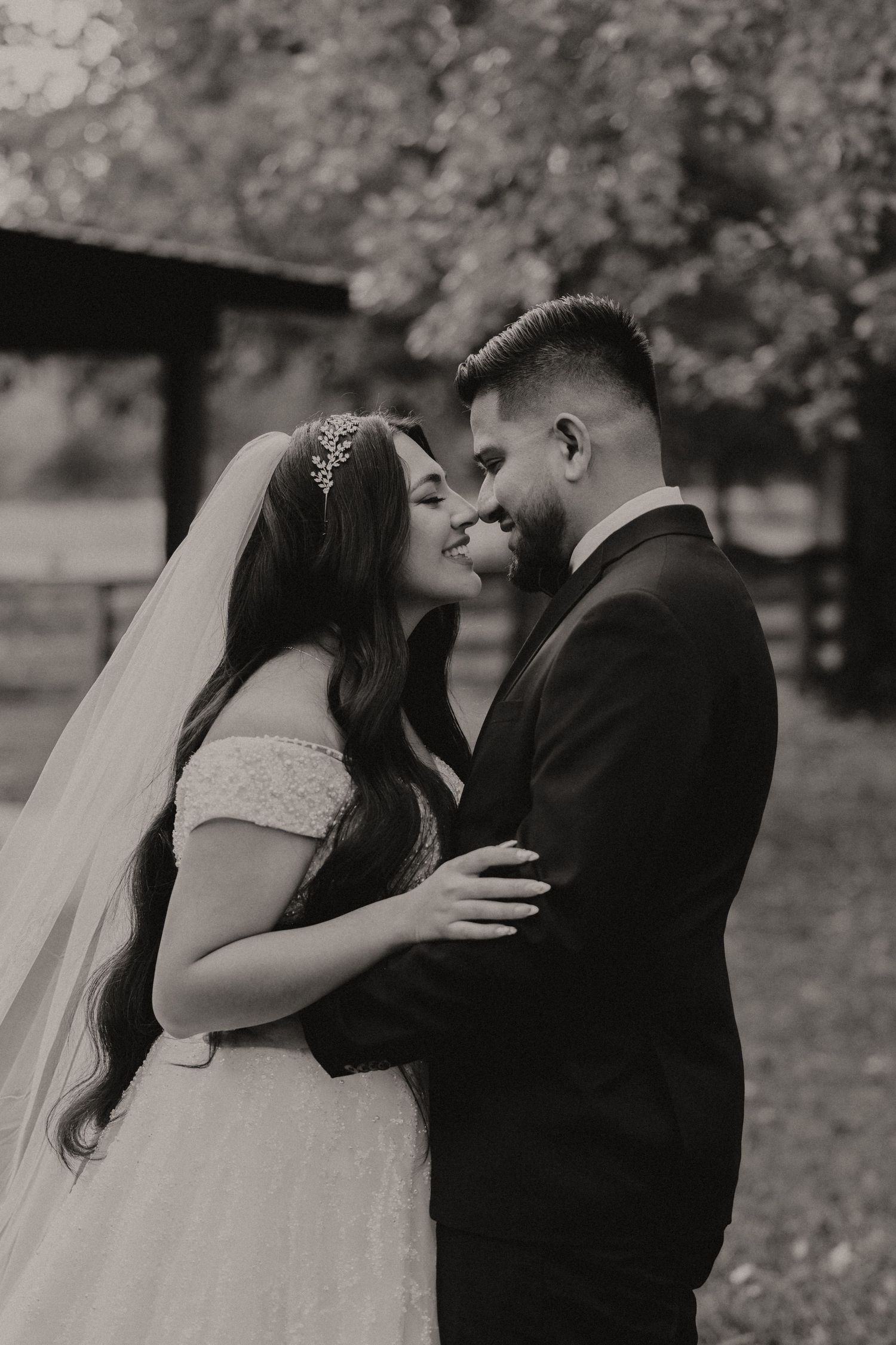 A romantic black and white photo sequence shows a couple sharing a tender kiss outdoors during their wedding day.