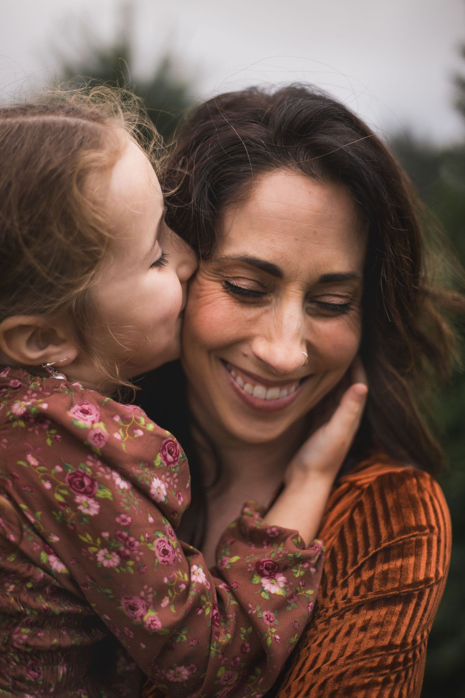 A tender moment between parent and child as they share an intimate embrace outdoors captured by your seattle family photographer