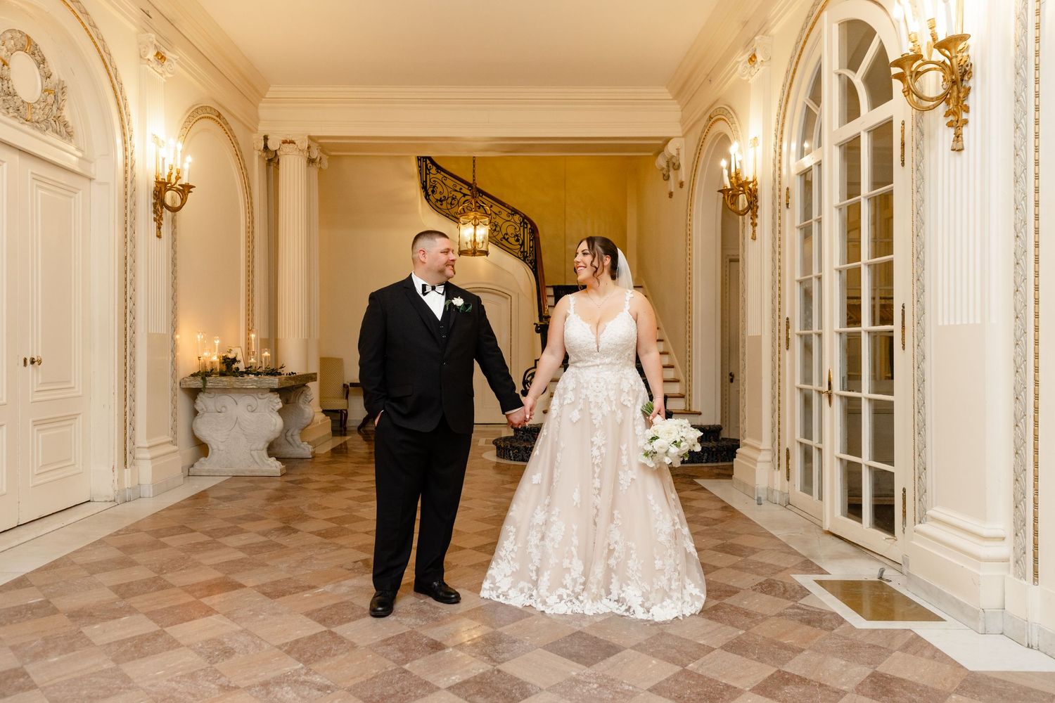 Tupper Manor wedding bride and groom portraits indoor winter wedding in the foyer with staircase Endicott College Beverly MA