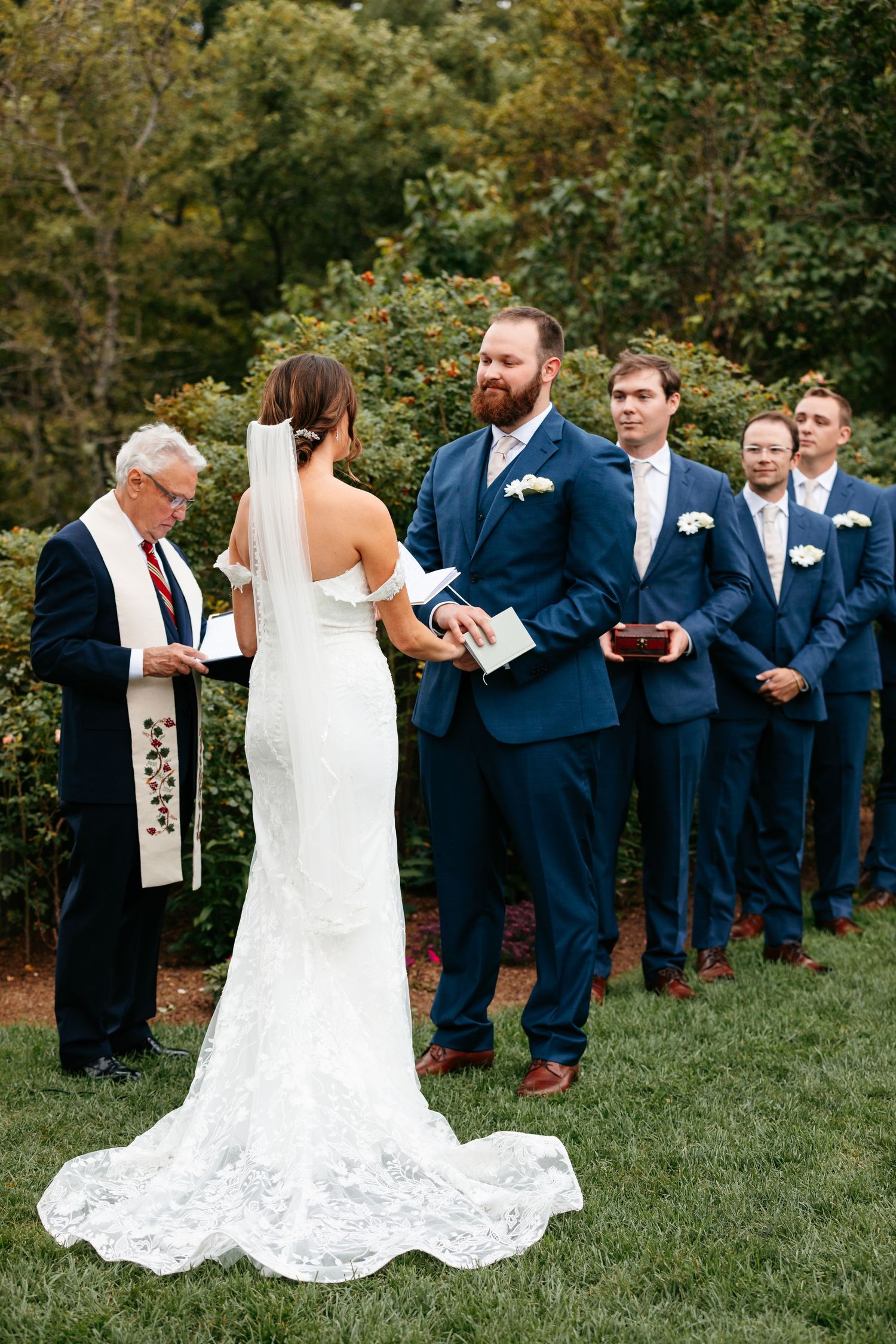 Summer wedding ceremony with bride and groom in navy suit at John Hay Estate at The Fells in Newbury, NH