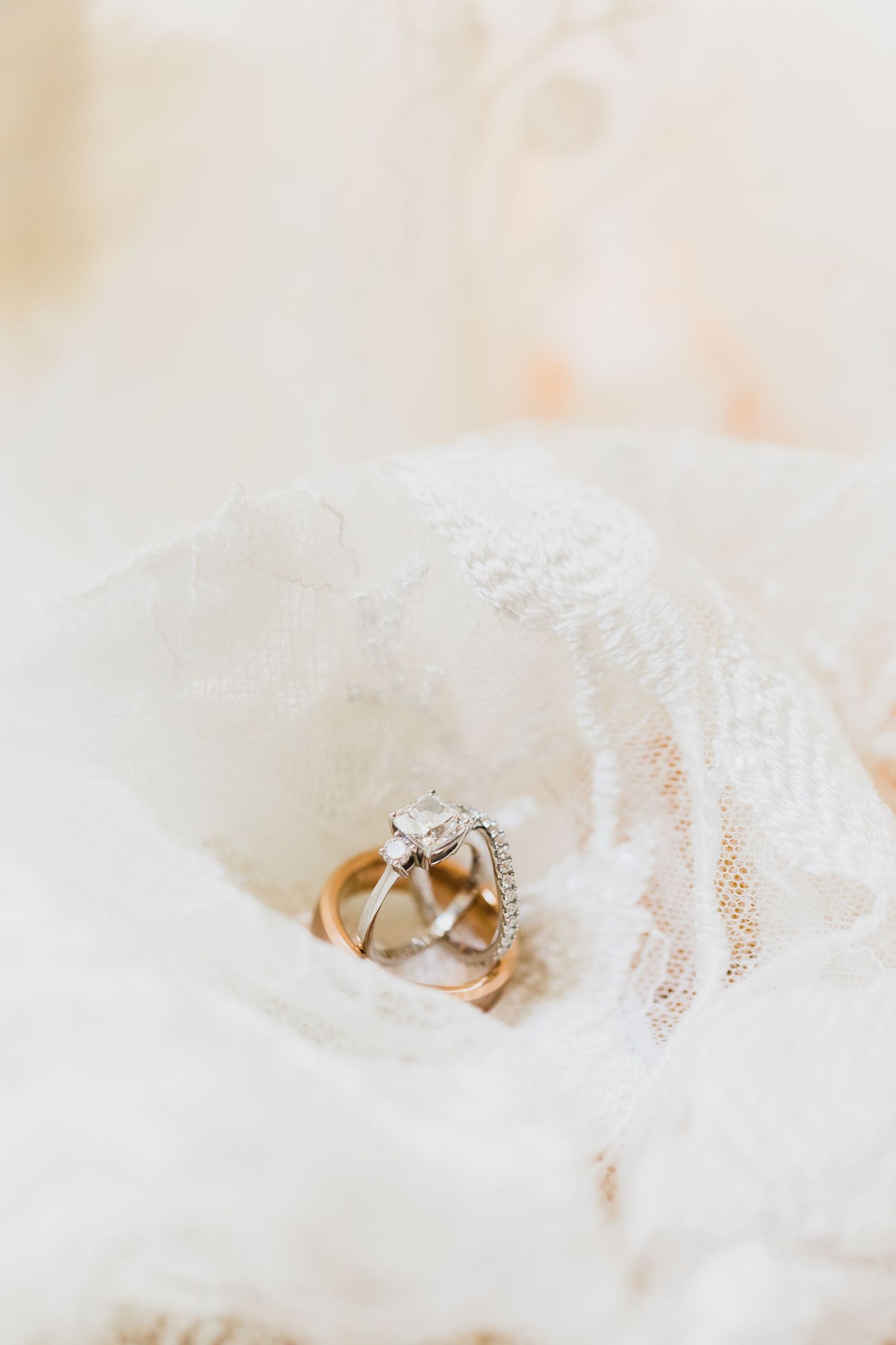 Detail shot of wedding rings on lace veil at Longlook Farm in Sanbornton, NH