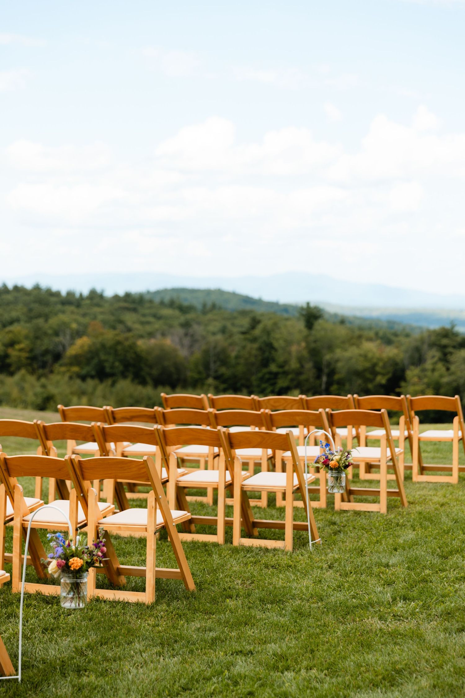 Steele Hill Resort summer wedding ceremony with chairs and aisle Sanbornton NH