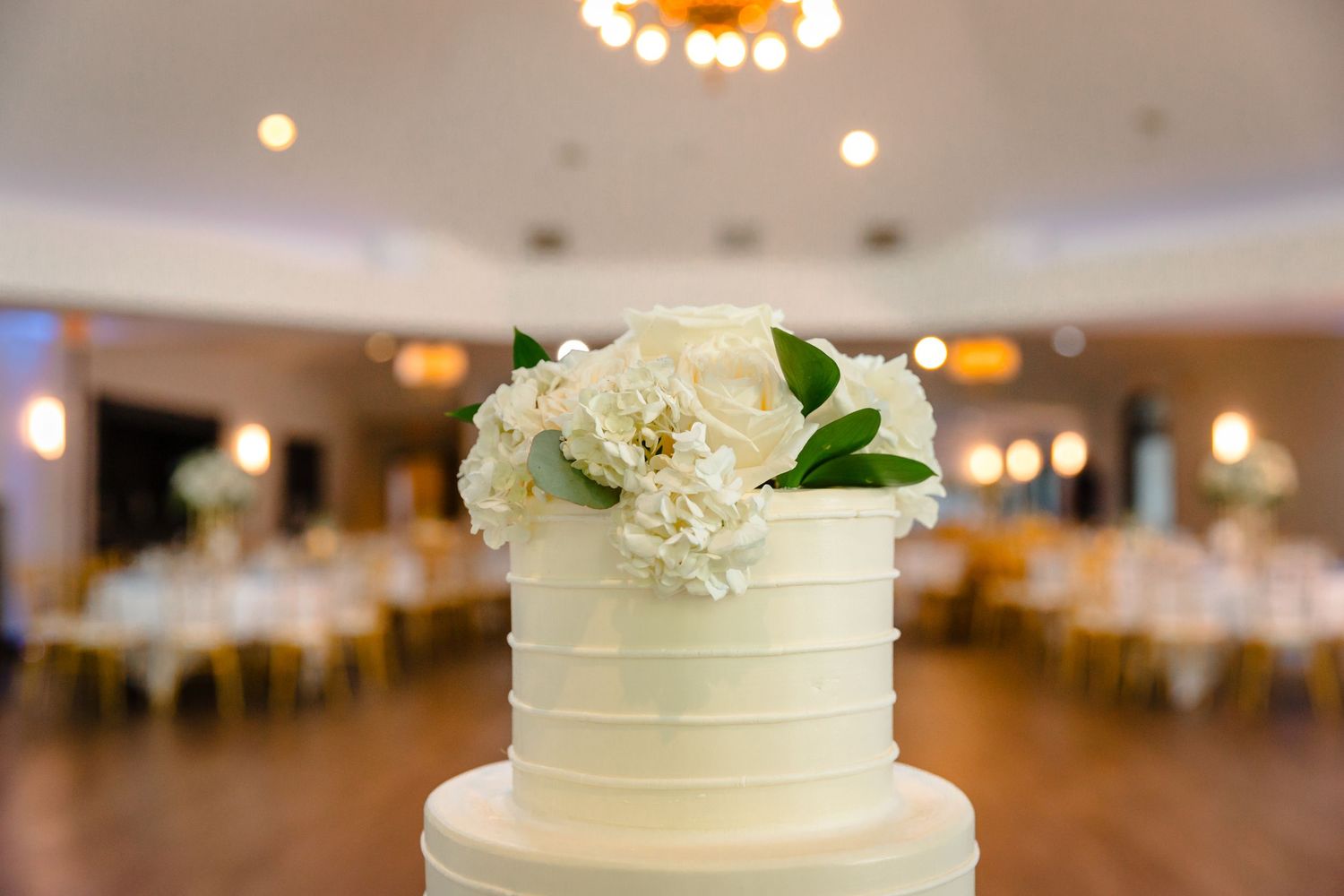 Granite Rose NH wedding reception area cake with white fresh florals