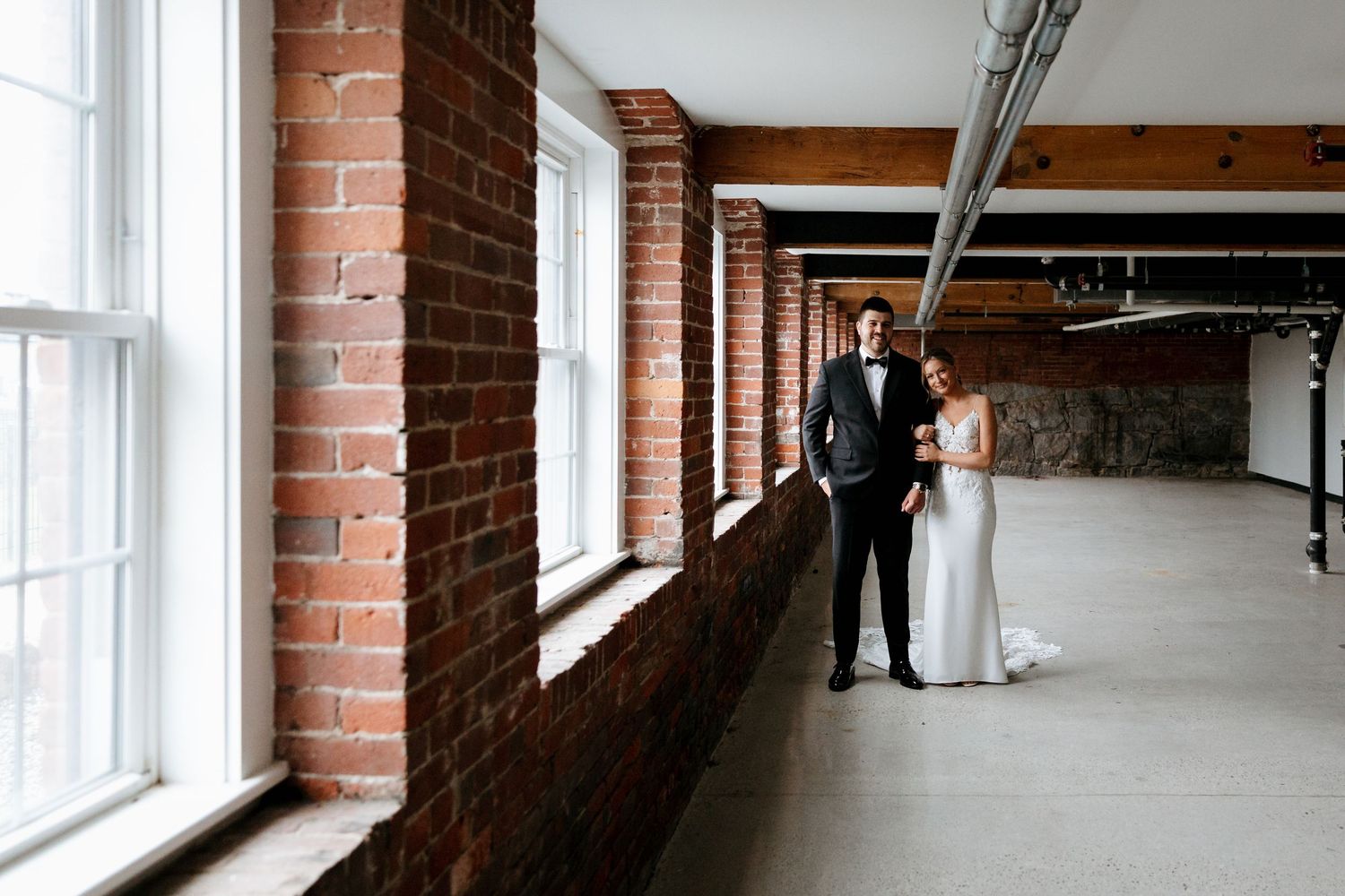 Venues at the Factory wedding Manchester NH industrial wedding bride and groom photo with bricks and natural light