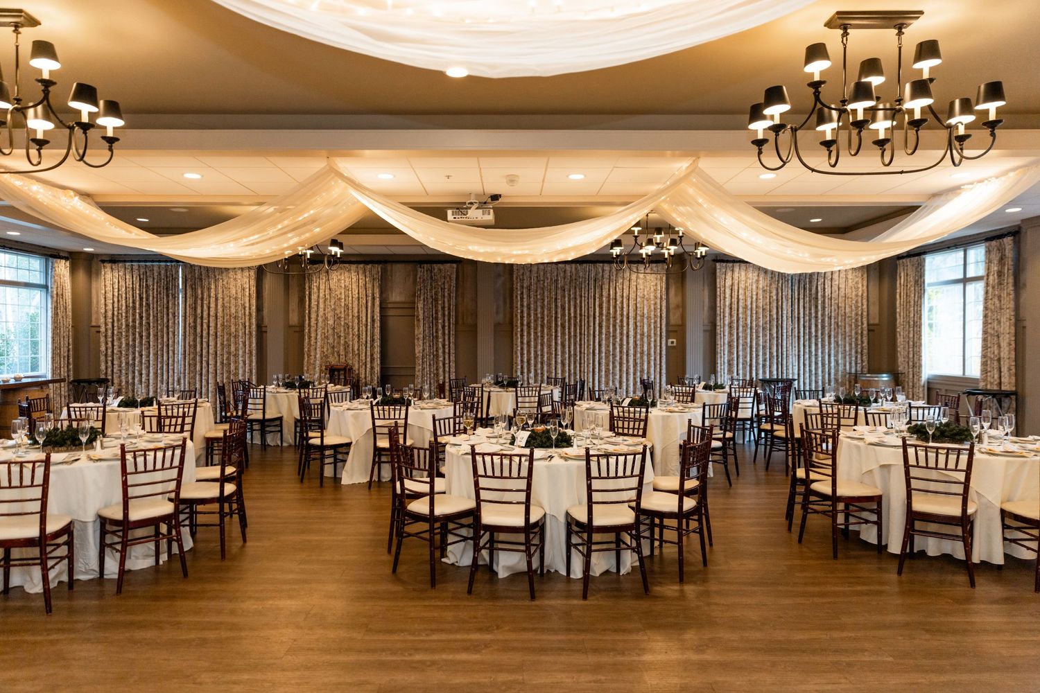 Labelle Winery wedding Derry NH reception area with tables and centerpieces and chandeliers