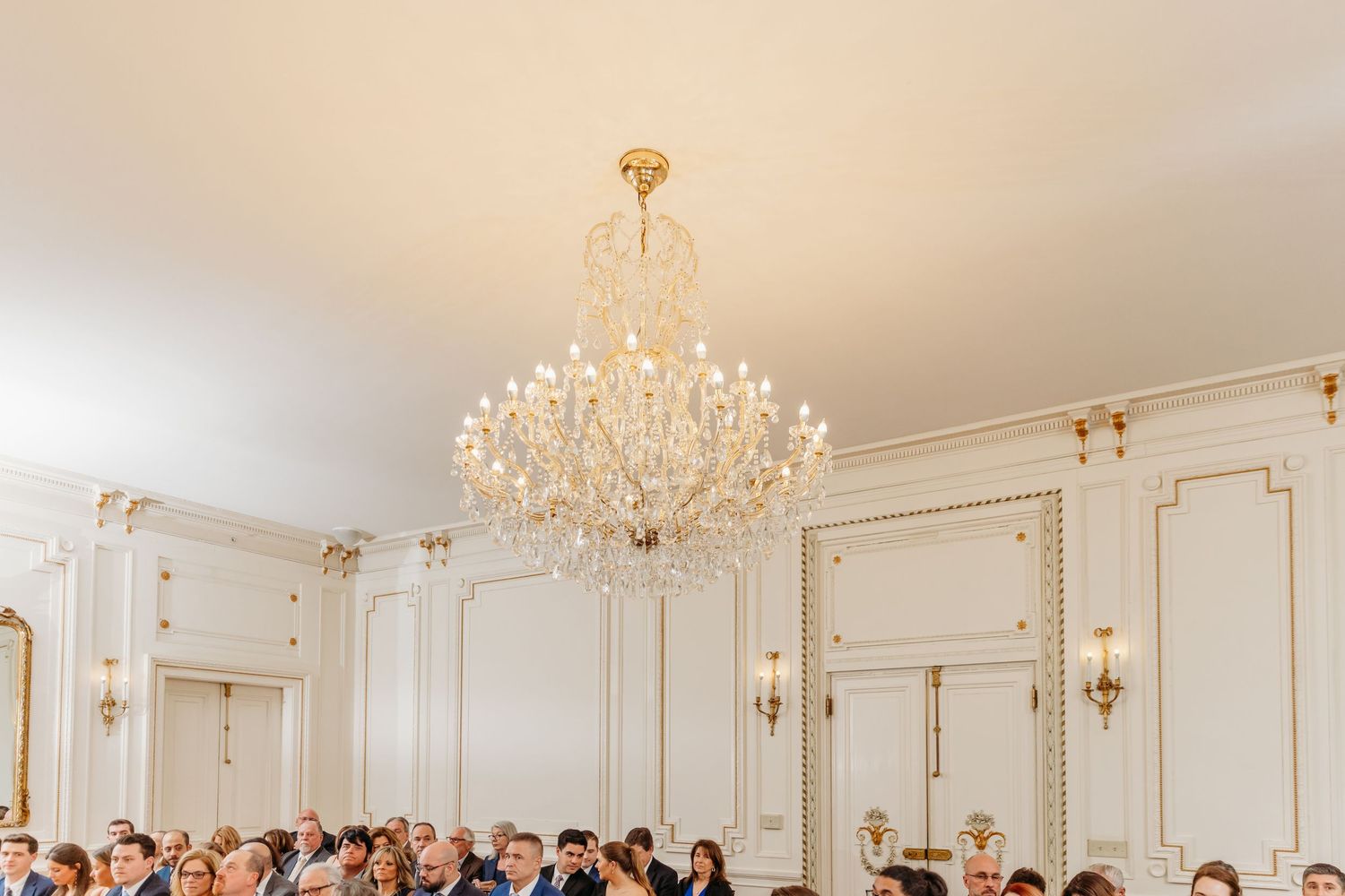 Tupper Manor wedding indoor ceremony winter wedding with guests and chandelier Endicott College Beverly MA