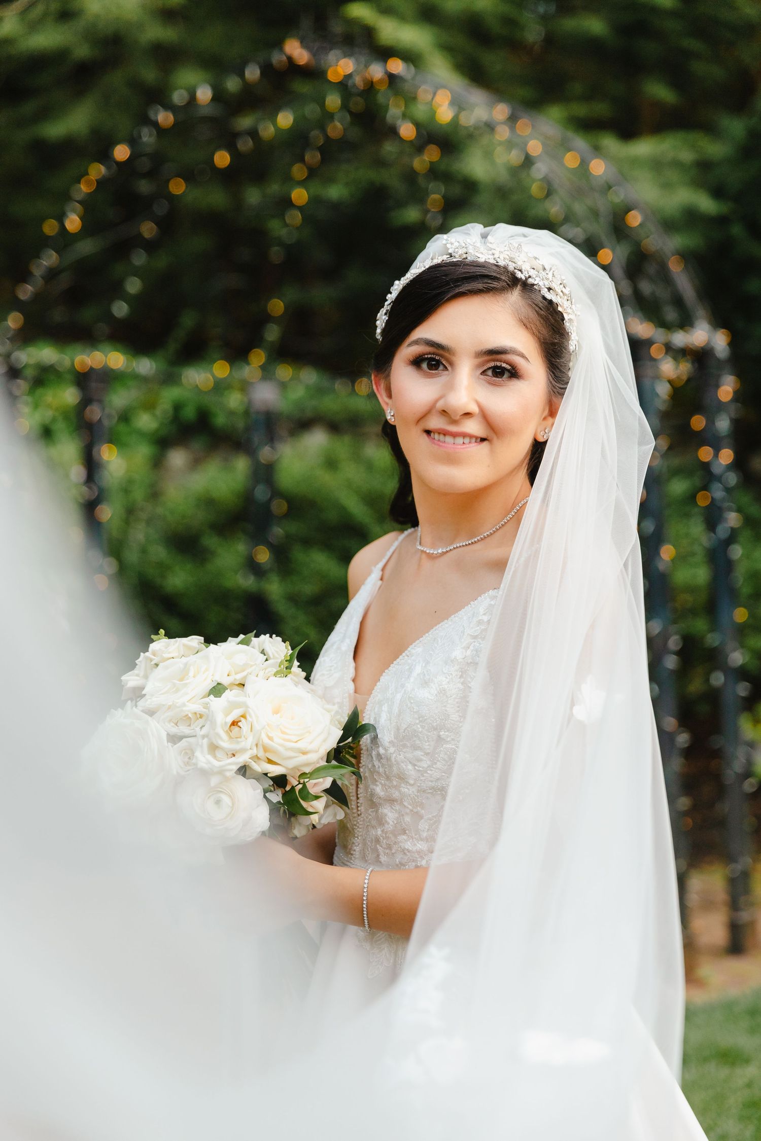 Portrait of Bride with veil and bouquet of white roses at summer wedding at Granite Rose in Hampstead, NH.