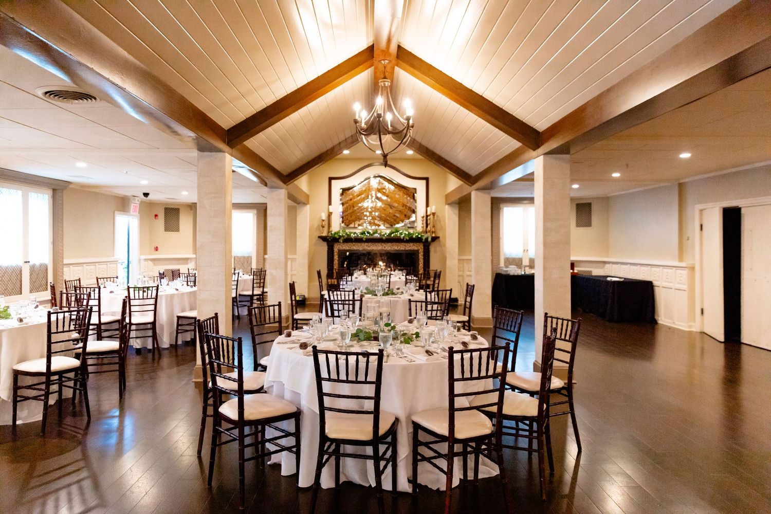 The Villa at Ridder Country Club wedding East Bridgewater MA reception space tables and centerpieces with fireplace