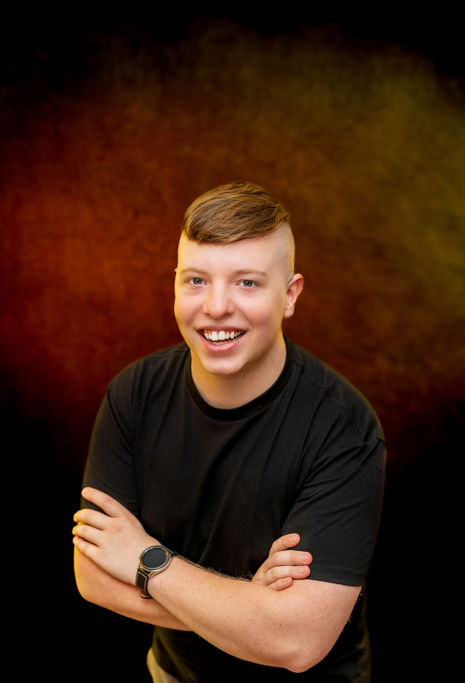 Studio portrait series against dark background showing various poses in black t-shirt.