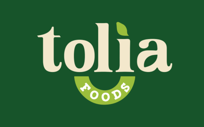 Tolia Foods logo featuring cream-colored text on a dark green background with a leaf accent.